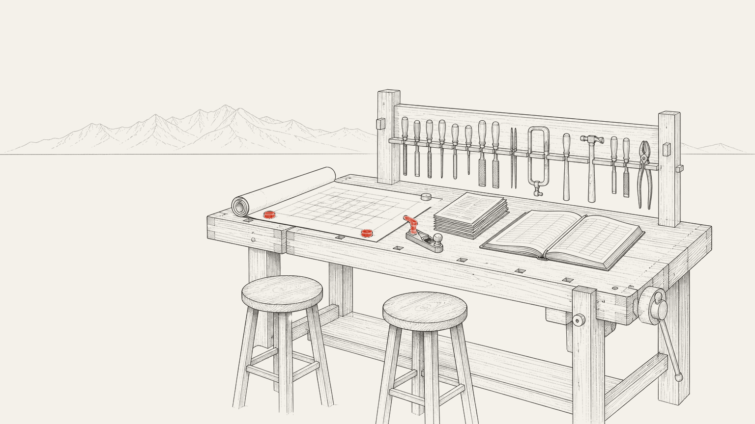 Two stools drawn up to a workbench spread with a company's own working papers, a rack of hand tools along the back, and one tool lifted out of its place and set down on the papers.